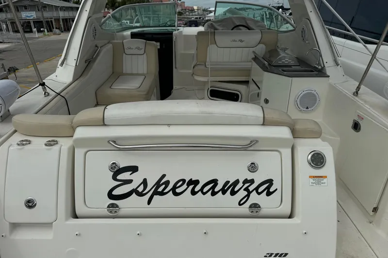 Slide: The Image of 2013 Sea Ray Sundancer 310 boat interior, named "Esperanza," docked at a marina. - 4
