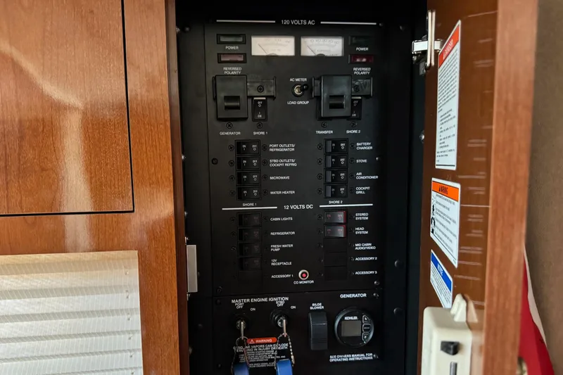 Slide: The Image of Electrical control panel of 2013 Sea Ray Sundancer 310 boat, featuring switches and labels. - 41
