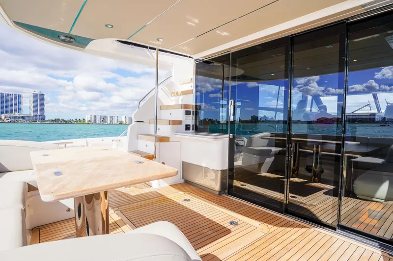 Slide: The Image of Luxurious 2022 Princess F62 yacht deck with elegant seating and ocean view. - 11