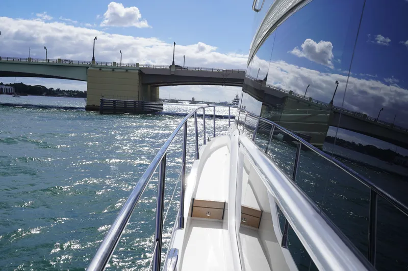 Slide: The Image of 2022 Princess F62 yacht cruising under a bridge on a sunny day. - 12
