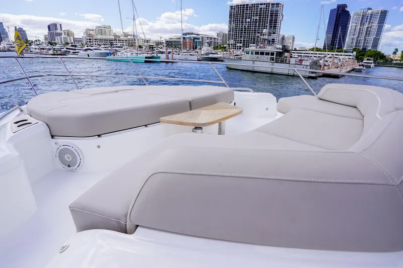 Slide: The Image of Luxurious 2022 Princess F62 yacht deck with plush seating and city skyline view. - 13