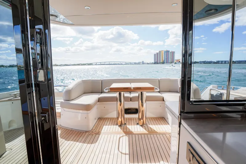 Slide: The Image of Luxurious 2022 Princess F62 yacht interior with ocean view, featuring elegant seating and table. - 17