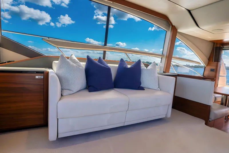 Slide: The Image of Luxurious interior of 2022 Princess F62 yacht with plush sofa and scenic window view. - 25