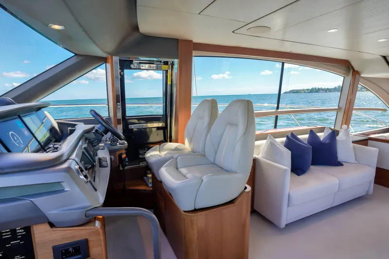 Slide: The Image of Luxurious 2022 Princess F62 yacht interior with helm, seating, and ocean view. - 26