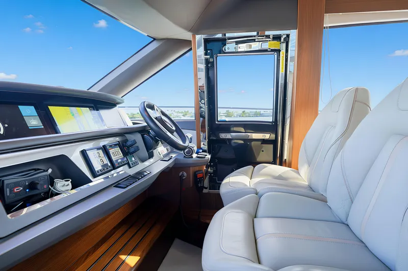 Slide: The Image of Luxurious 2022 Princess F62 yacht cockpit with modern controls and plush seating. - 27