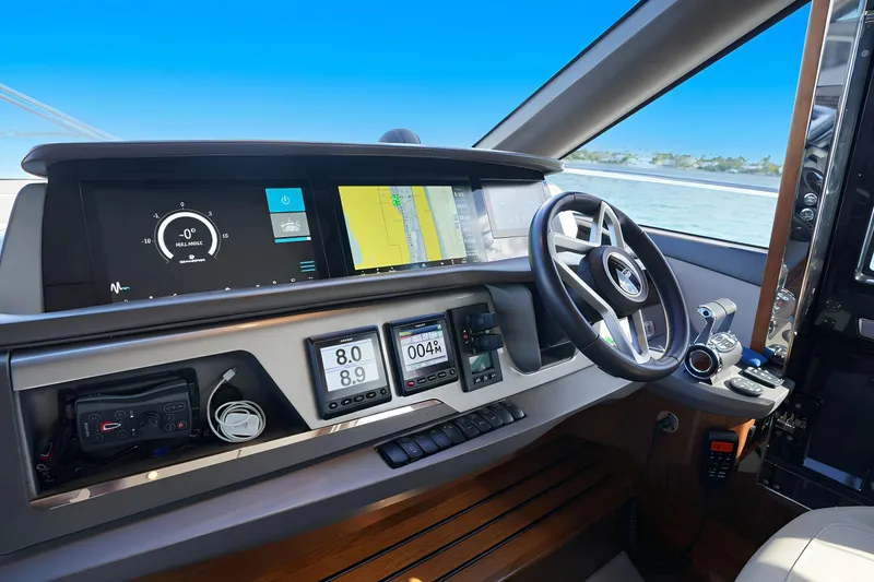 Slide: The Image of Modern helm of 2022 Princess F62 yacht with advanced navigation displays and controls. - 28