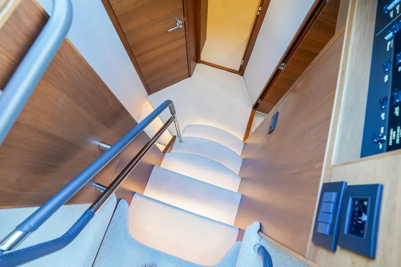 Slide: The Image of Staircase inside 2022 Princess F62 yacht, featuring sleek wood and modern design. - 31