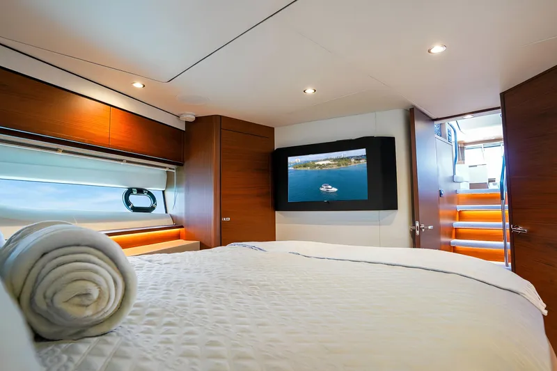 Slide: The Image of Luxurious bedroom interior of 2022 Princess F62 yacht with TV and elegant decor. - 41