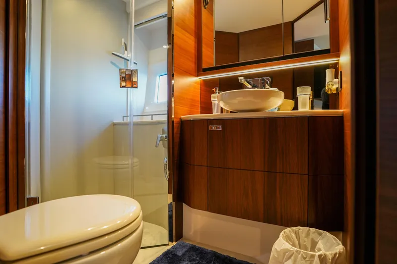 Slide: The Image of Luxurious bathroom in 2022 Princess F62 yacht with modern fixtures and wooden cabinetry. - 43