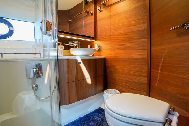 Slide: The Image of Luxurious bathroom in 2022 Princess F62 yacht with wood accents and modern fixtures. - 44