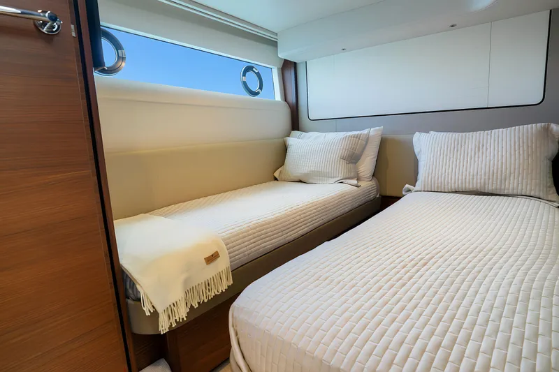 Slide: The Image of Luxurious twin cabin interior on 2022 Princess F62 yacht, featuring elegant bedding and modern design. - 46