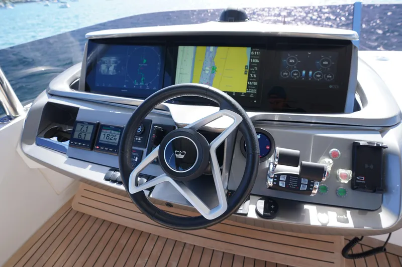 Slide: The Image of Helm of 2022 Princess F62 yacht with advanced navigation displays and controls. - 54