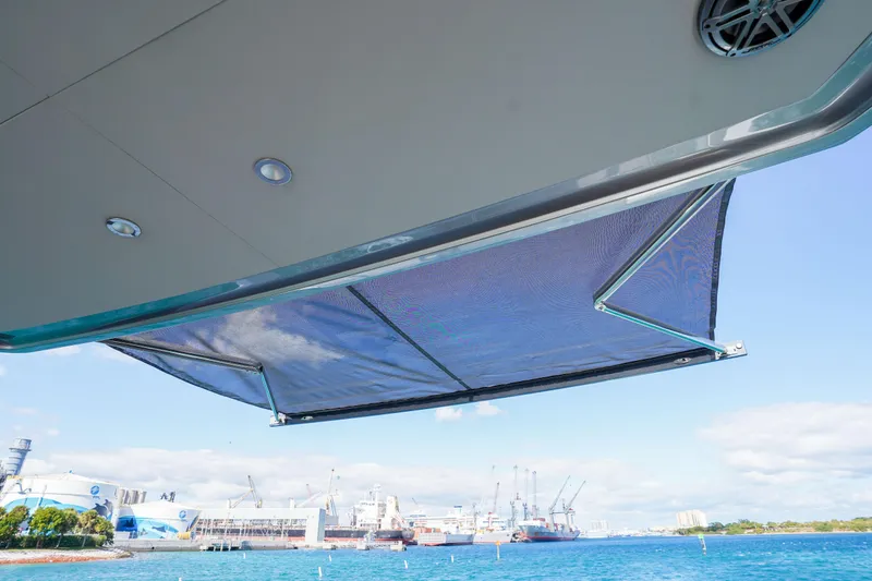 Slide: The Image of 2022 Princess F62 yacht with extended sunshade, overlooking a harbor. - 56