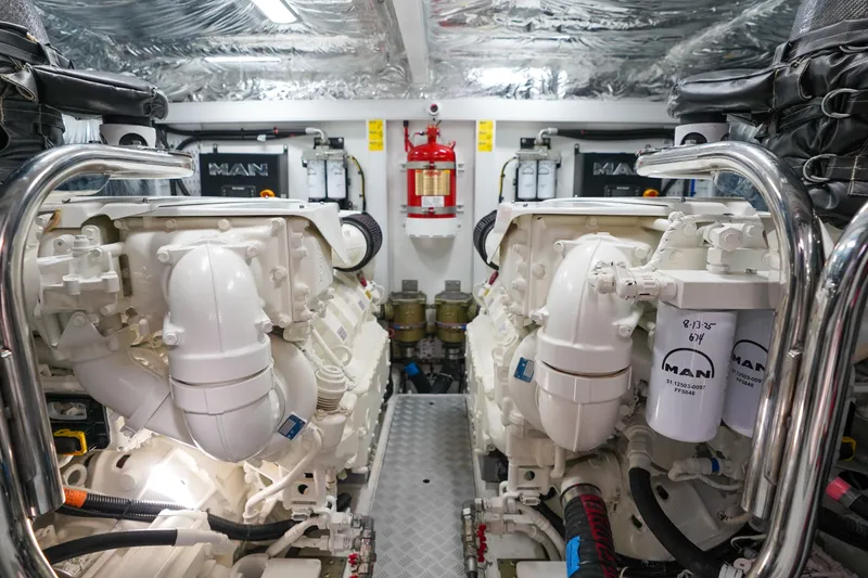 Slide: The Image of Engine room of a 2022 Princess F62 yacht, featuring dual MAN engines. - 58