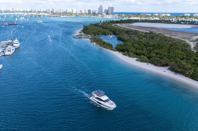 Slide: The Image of Aerial view of 2022 Princess F62 yacht cruising near a scenic coastline. - 7