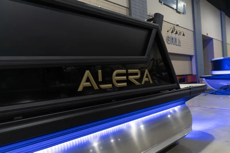 Slide: The Image of Alera M23Q 2026 boat with illuminated blue accents in an indoor setting. - 8