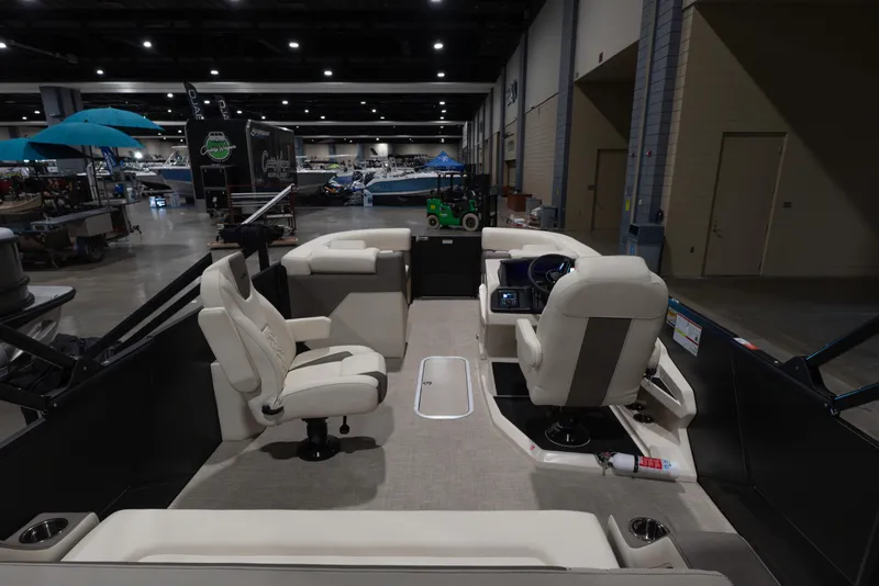 Slide: The Image of 2026 Alera M23Q boat interior at an indoor exhibition, featuring modern seating and controls. - 10
