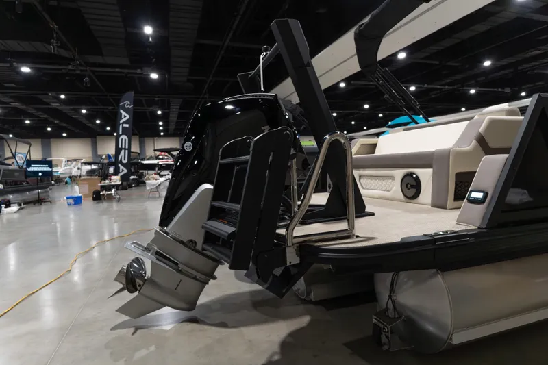 Slide: The Image of 2026 Alera M23Q boat displayed indoors with motor and seating area visible. - 3