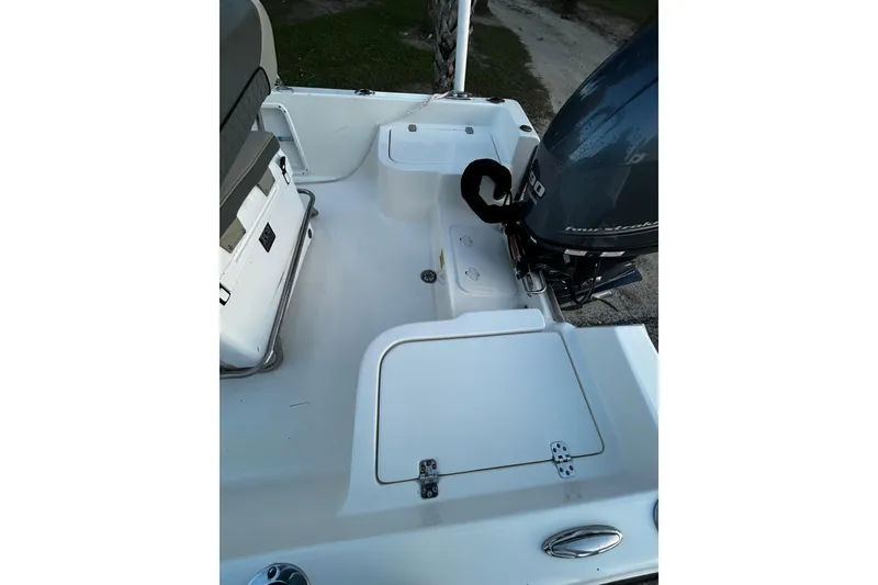 Slide: The Image of 2025 Key West 1720 Center Console boat interior with motor and seating. - 14