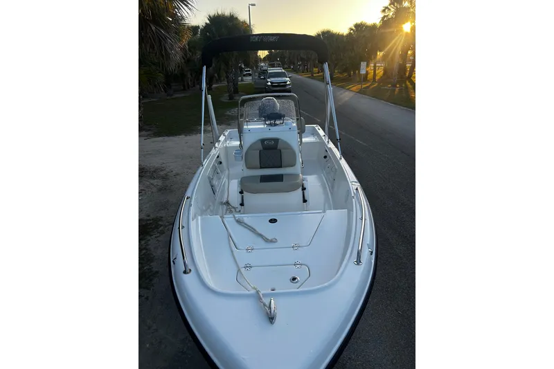 Slide: The Image of 2025 Key West 1720 Center Console boat parked on a road at sunset. - 3