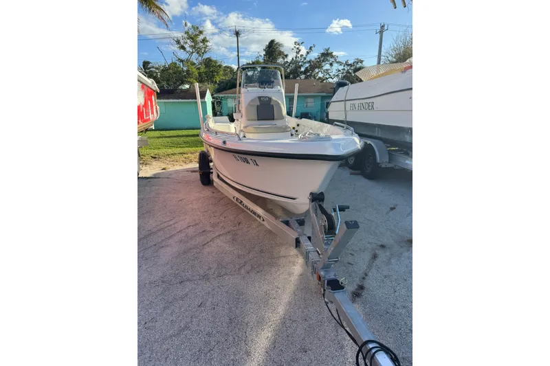 Slide: The Image of 2025 Key West 1720 Center Console boat on trailer, parked outdoors. - 9