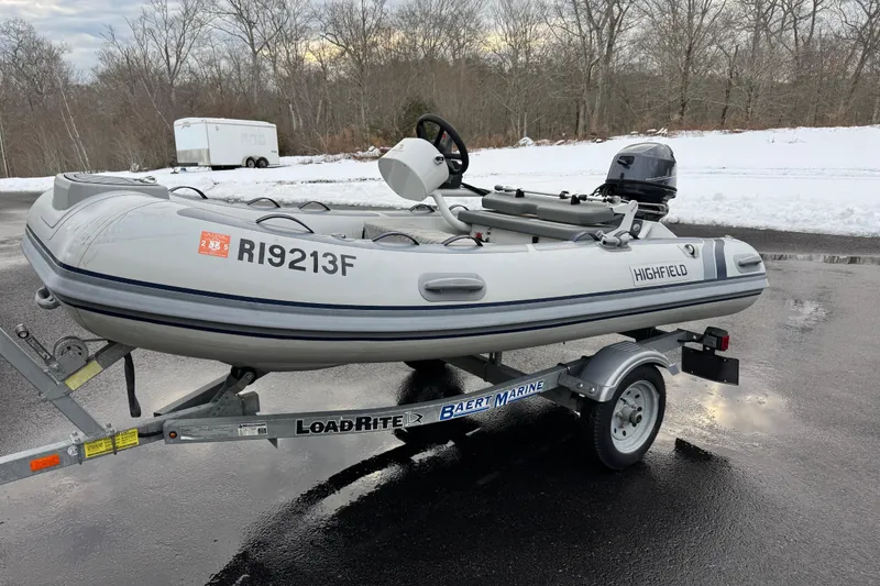 The Image of 2023 Highfield Classic 340 inflatable boat on trailer in snowy outdoor setting. - 1