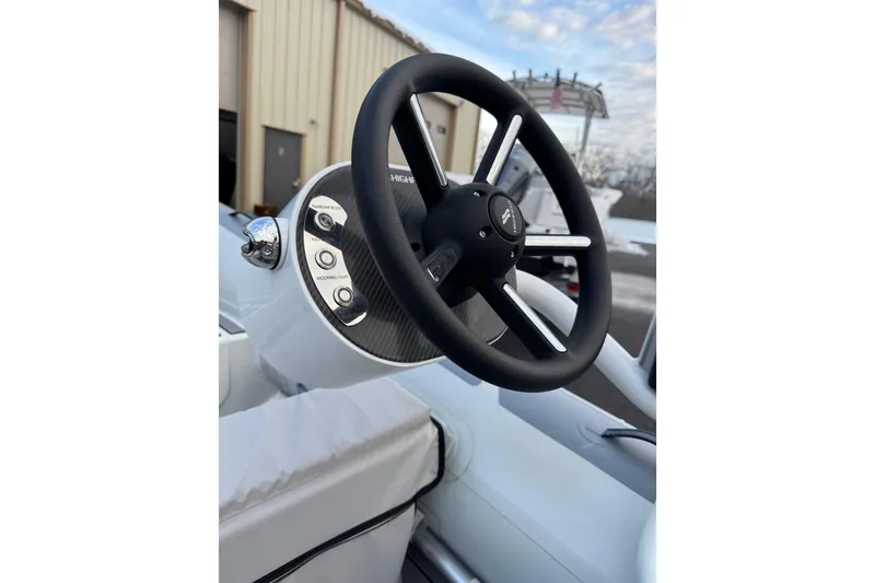 Slide: The Image of Steering wheel of 2023 Highfield Classic 340 boat, featuring modern controls and sleek design. - 10