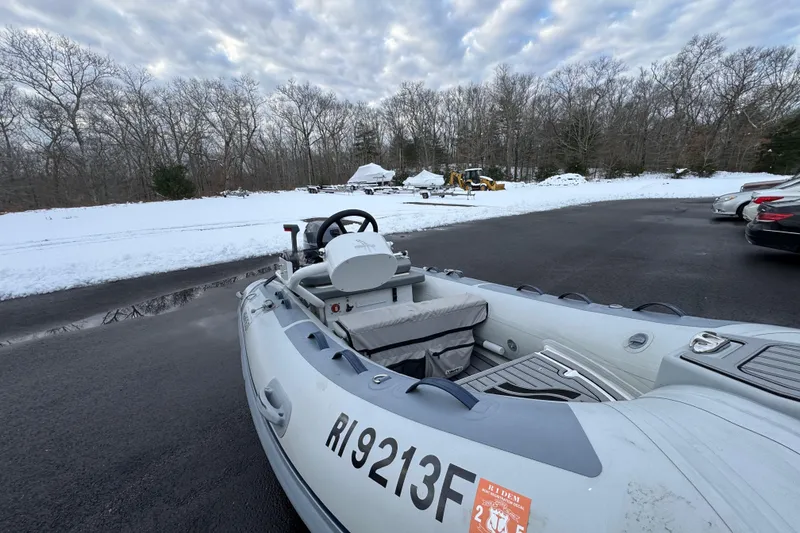 Slide: The Image of 2023 Highfield Classic 340 inflatable boat on snowy pavement, surrounded by trees. - 15