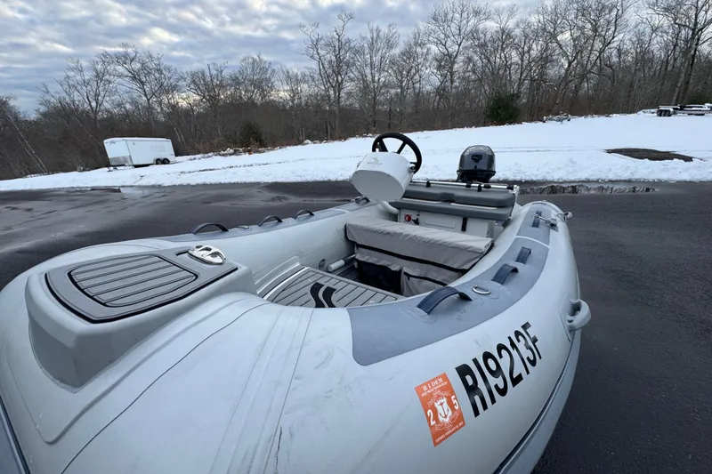 Slide: The Image of 2023 Highfield Classic 340 inflatable boat on snowy pavement, surrounded by trees. - 16