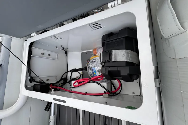 Slide: The Image of Interior view of 2023 Highfield Classic 340 boat storage compartment with battery and wiring. - 3