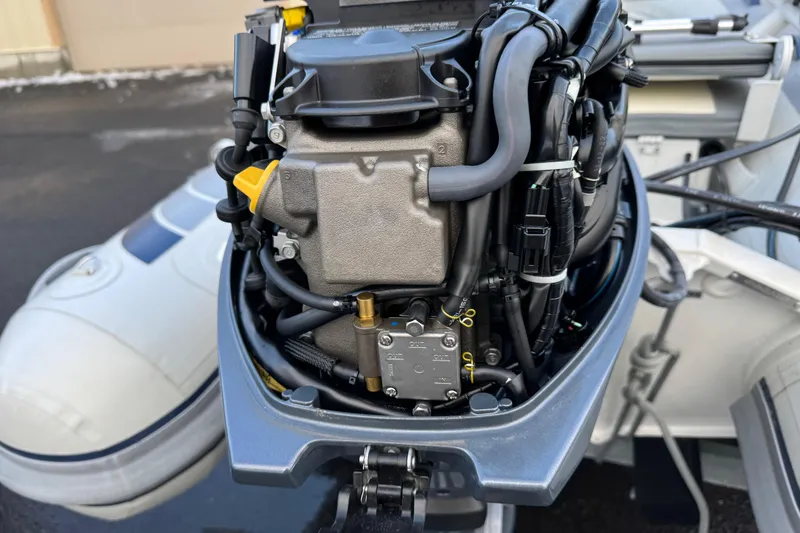 Slide: The Image of 2023 Highfield Classic 340 outboard motor close-up, showcasing engine components and wiring. - 8