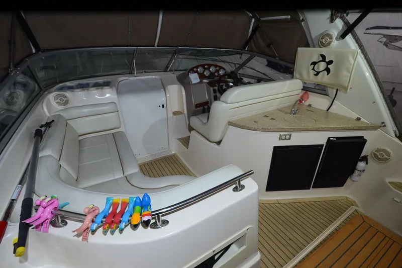 Slide: The Image of 2005 Rinker Fiesta Vee 342 boat interior with seating, helm, and colorful toys. - 21
