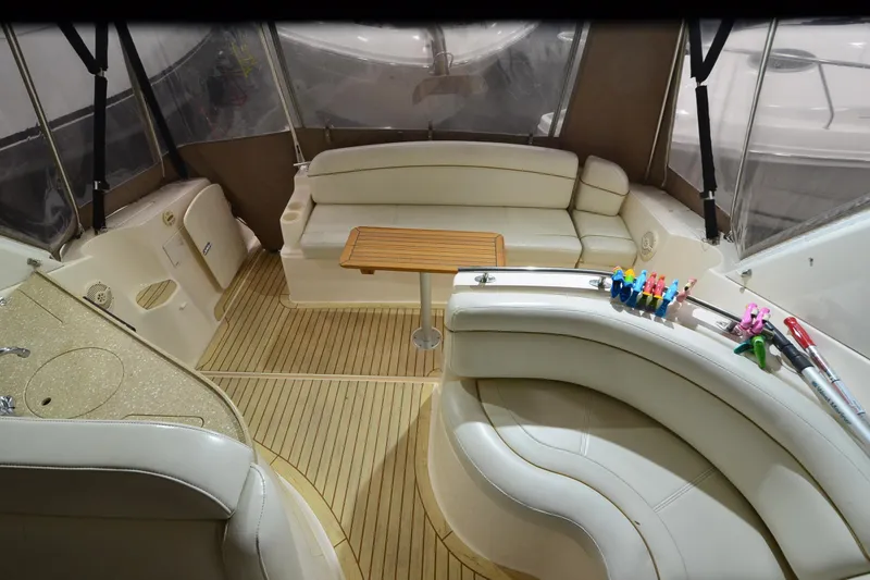 Slide: The Image of 2005 Rinker Fiesta Vee 342 interior with beige seating and wooden table. - 23