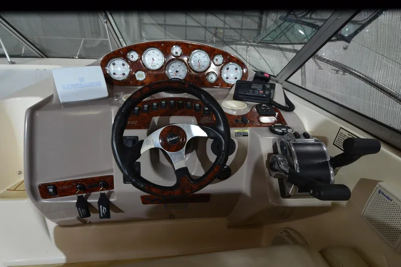 Slide: The Image of 2005 Rinker Fiesta Vee 342 boat dashboard with steering wheel and control panel. - 26