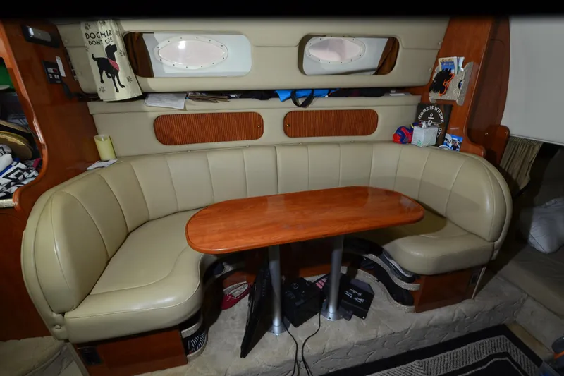 Slide: The Image of 2005 Rinker Fiesta Vee 342 interior with beige seating and wooden table. - 27