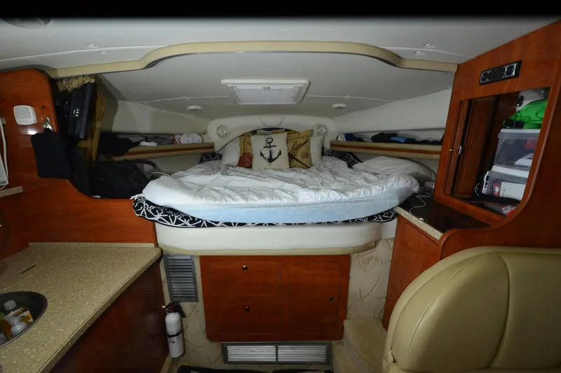 Slide: The Image of Interior cabin of 2005 Rinker Fiesta Vee 342 with cozy bed and wooden cabinetry. - 30