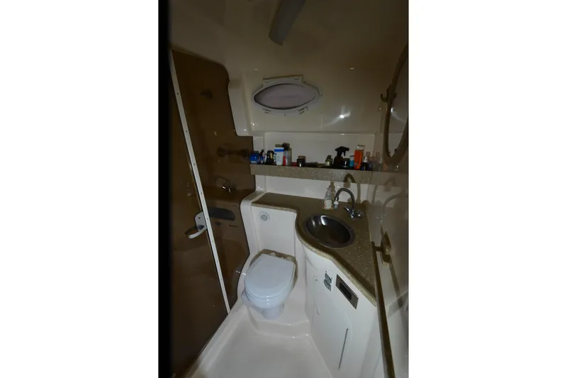 Slide: The Image of 2005 Rinker Fiesta Vee 342 bathroom with sink, toilet, and storage shelf. - 33