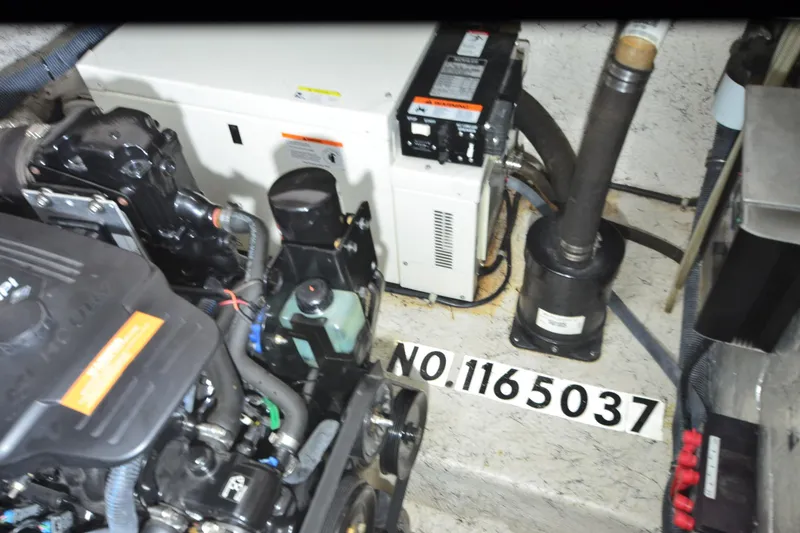 Slide: The Image of Engine compartment of 2005 Rinker Fiesta Vee 342 with visible components and serial number. - 35