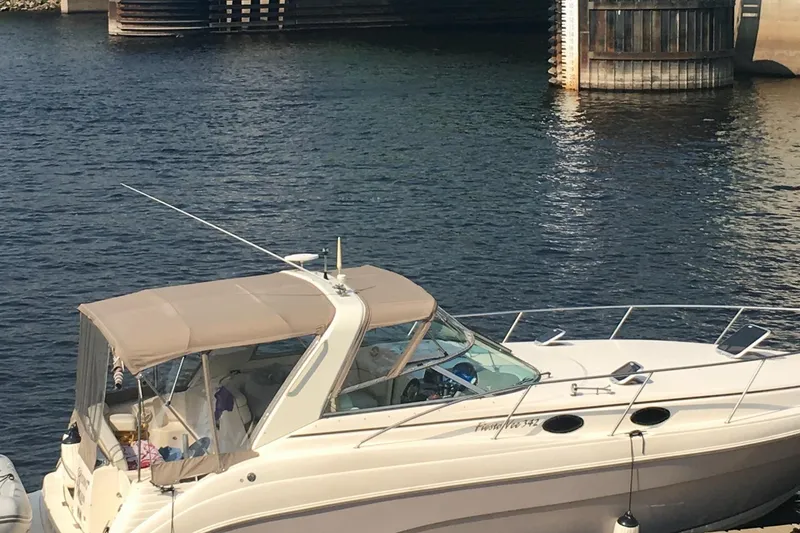 Slide: The Image of 2005 Rinker Fiesta Vee 342 boat docked near wooden structure on water. - 40