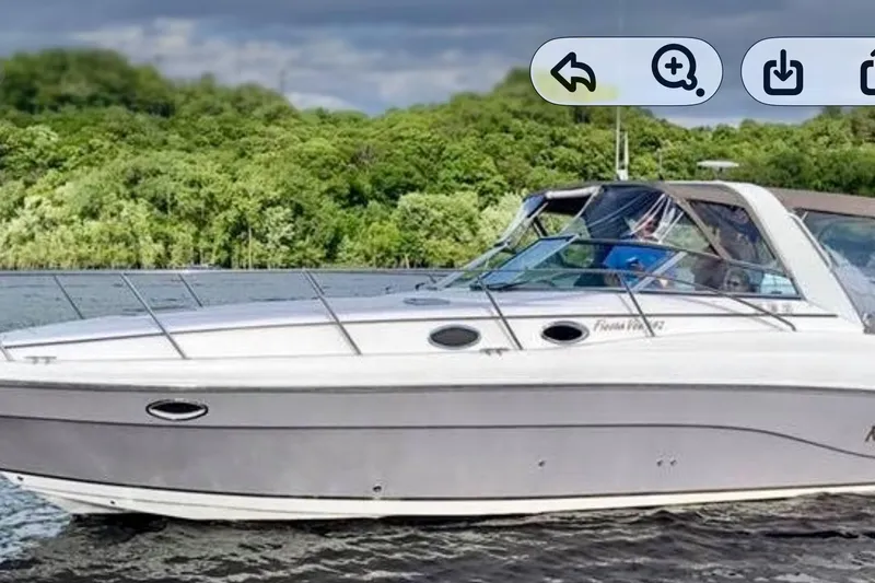 Slide: The Image of 2005 Rinker Fiesta Vee 342 boat cruising on a scenic lake with lush green trees. - 41