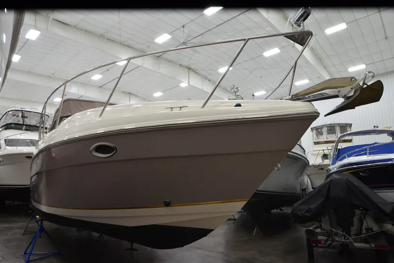 Slide: The Image of 2005 Rinker Fiesta Vee 342 boat in indoor storage, showcasing sleek design and sturdy build. - 5