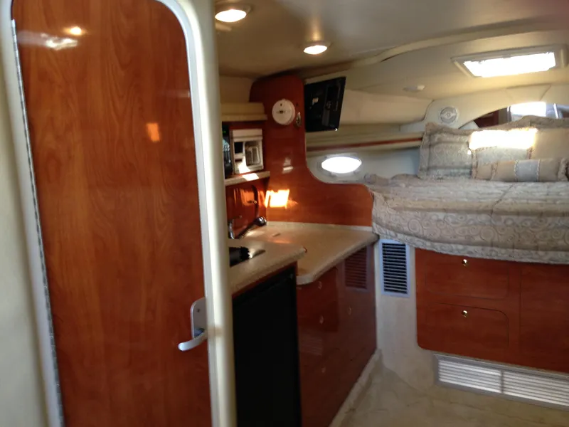 Slide: The Image of 2005 Rinker Fiesta Vee 342 cabin interior with bed and kitchenette. - 8
