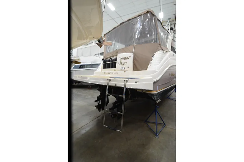 Slide: The Image of 2005 Rinker Fiesta Vee 342 boat in storage, rear view with cover and ladder. - 9
