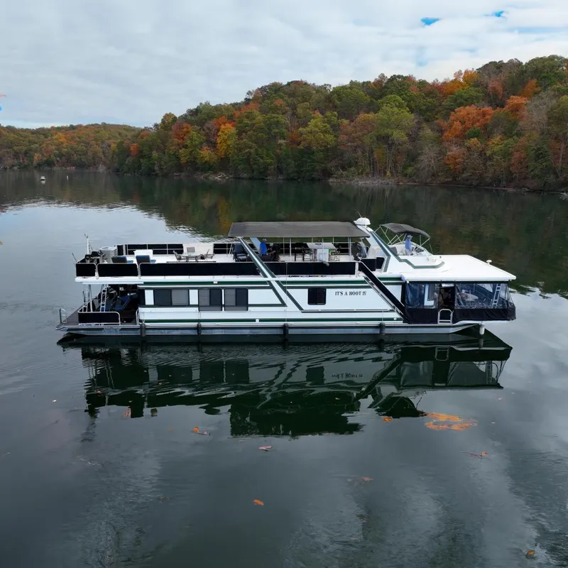 The Image of Sumerset 82'x18' Widebody houseboat on calm lake, autumn scenery. - 0