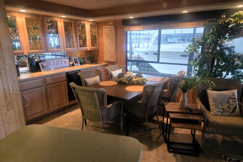 Slide: The Image of Luxurious 1996 Sumerset houseboat interior with dining area, wicker chairs, and large window view. - 10