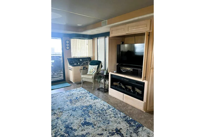 Slide: The Image of Interior of 1996 Sumerset 82'x18' Widebody with TV, fireplace, and seating area. - 12