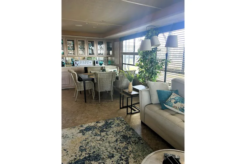 Slide: The Image of Interior of 1996 Sumerset 82'x18' Widebody houseboat with cozy seating and dining area. - 13