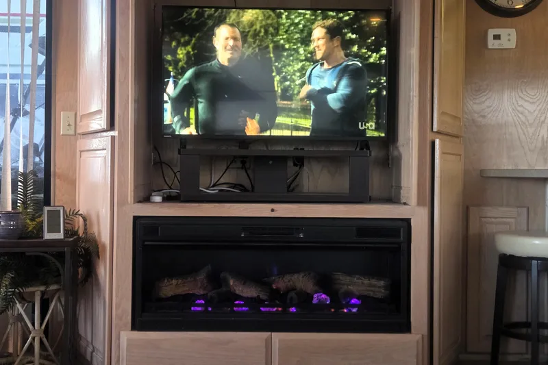 Slide: The Image of Entertainment center with TV and electric fireplace in 1996 Sumerset 82'x18' Widebody houseboat. - 14