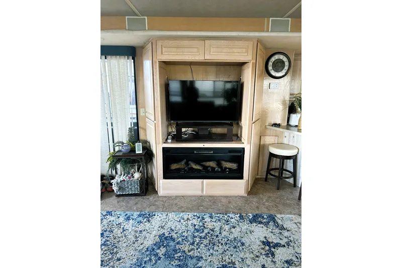 Slide: The Image of Living area in 1996 Sumerset 82'x18' Widebody with TV and fireplace. - 15