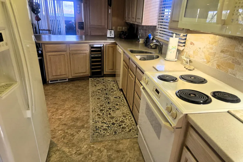 Slide: The Image of Kitchen interior of a 1996 Sumerset 82'x18' Widebody houseboat with modern appliances. - 20